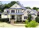 Charming two-story brick home with a manicured front yard and inviting covered front porch at 1512 Obrien Cir, Wake Forest, NC 27587
