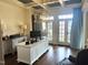 Bright home office with custom built-ins, coffered ceiling and large windows with blue accent draperies at 1512 Obrien Cir, Wake Forest, NC 27587