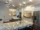 Bright kitchen featuring white cabinetry, granite countertops, stainless steel appliances, and double islands at 1512 Obrien Cir, Wake Forest, NC 27587
