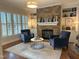 Cozy living room with a stone fireplace, built-in shelving, plantation shutters and hardwood floors at 1512 Obrien Cir, Wake Forest, NC 27587