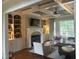 Comfortable living room featuring a fireplace, built-in shelving, hardwood floors and a ceiling fan at 1512 Obrien Cir, Wake Forest, NC 27587