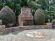 Stone outdoor fireplace with brick patio, perfect for entertaining and enjoying cozy evenings at 1512 Obrien Cir, Wake Forest, NC 27587