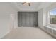 Spacious bedroom featuring a tray ceiling, statement wall, and built-in window seat with storage at 156 Harmony Trl, Broadway, NC 27505