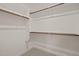 Spacious closet features wooden rods and white shelving for optimal storage and organization solutions at 156 Harmony Trl, Broadway, NC 27505