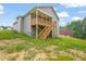 Gray home featuring a wooden porch with stairs and grassy lawn at 156 Harmony Trl, Broadway, NC 27505