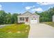 Charming single-story home with a well-manicured lawn, attached garage and inviting red front door at 156 Harmony Trl, Broadway, NC 27505