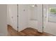 Hallway view with doors leading to a bedroom featuring carpet flooring and a ceiling fan at 156 Harmony Trl, Broadway, NC 27505