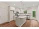 Modern kitchen with white cabinets, granite countertops, stainless steel appliances, and a center island at 156 Harmony Trl, Broadway, NC 27505