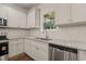 Modern kitchen with stainless steel appliances, granite counters, white cabinets and subway tile backsplash at 156 Harmony Trl, Broadway, NC 27505