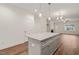 Kitchen view showcasing an island with granite countertops, gray cabinetry, and wood flooring at 156 Harmony Trl, Broadway, NC 27505