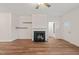 Inviting living room featuring a fireplace, ceiling fan, and warm, inviting hardwood floors at 156 Harmony Trl, Broadway, NC 27505