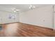 Well-lit living area with hardwood floors, featuring a ceiling fan and access to a bright entryway at 156 Harmony Trl, Broadway, NC 27505