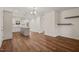Open living space featuring a kitchen island, hardwood floors, white walls and ample natural light at 156 Harmony Trl, Broadway, NC 27505