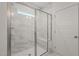 Elegant walk-in shower featuring tile walls, glass doors, and built-in niche and seating at 156 Harmony Trl, Broadway, NC 27505