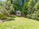 Landscaped backyard featuring a charming playhouse and lush greenery at 1901 White Oak Rd, Raleigh, NC 27608