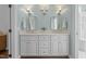 Double vanity bathroom featuring updated cabinetry, light fixtures and a wall mirror at 1901 White Oak Rd, Raleigh, NC 27608