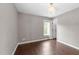 Neutral bedroom with a decorative light fixture, hardwood floors, and a window at 1901 White Oak Rd, Raleigh, NC 27608