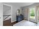 Bright bedroom featuring a gray wall, white trim, and a navy accent table at 1901 White Oak Rd, Raleigh, NC 27608