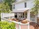 Elevated outdoor deck featuring stylish seating, a retractable awning, and a view of the lush backyard at 1901 White Oak Rd, Raleigh, NC 27608