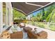 Spacious outdoor deck featuring comfortable wicker seating, a retractable awning, and serene backyard views at 1901 White Oak Rd, Raleigh, NC 27608