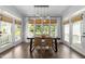 Bright dining room featuring a large table, woven chairs, and doors leading to the deck at 1901 White Oak Rd, Raleigh, NC 27608