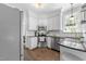 Well-lit kitchen featuring stainless steel appliances, black countertops, and white cabinets for a modern look at 1901 White Oak Rd, Raleigh, NC 27608