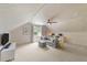 Cozy attic living room with white paneling, modern furniture, and a ceiling fan at 1901 White Oak Rd, Raleigh, NC 27608