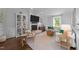 Stylish living room with a brick fireplace, white sofa, and hardwood floors offering a cozy retreat at 1901 White Oak Rd, Raleigh, NC 27608