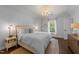 Calm main bedroom with neutral decor, wood floors and a chandelier at 1901 White Oak Rd, Raleigh, NC 27608