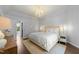 Bright main bedroom with a neutral color palette, wood floors and a door to another room at 1901 White Oak Rd, Raleigh, NC 27608
