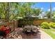 Outdoor patio with brick flooring, a dining table set, grill, and a fenced backyard for private enjoyment at 1901 White Oak Rd, Raleigh, NC 27608