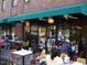 Outdoor seating at a restaurant with a green awning and visible signage at 1901 White Oak Rd, Raleigh, NC 27608