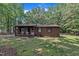 Lovely brick home with a covered front porch, featuring well-kept lawn and simple landscaping at 2005 Messer Rd, Raleigh, NC 27603