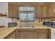 Close up of kitchen sink, cabinets, microwave, and stove at 2005 Messer Rd, Raleigh, NC 27603