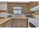 Traditional kitchen features wood cabinets with a window over the sink at 2005 Messer Rd, Raleigh, NC 27603