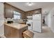 Traditional kitchen features wood cabinets and includes white appliances at 2005 Messer Rd, Raleigh, NC 27603