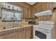 Close up of kitchen sink, cabinets, microwave, and stove at 2005 Messer Rd, Raleigh, NC 27603