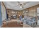 Cozy living room features wood paneling, a brick fireplace, and comfortable seating arrangement at 2005 Messer Rd, Raleigh, NC 27603