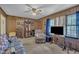 Spacious living room with wood-paneled walls, featuring a comfortable recliner and entertainment center at 2005 Messer Rd, Raleigh, NC 27603