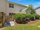 Backyard with patio, fence and shrubs creating a private outdoor living space at 2021 Rivergate Rd # 102, Raleigh, NC 27614