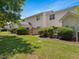 Exterior view of the townhome backyard showing the patio, fence, shrubs and air conditioner at 2021 Rivergate Rd # 102, Raleigh, NC 27614