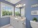 Bathroom showcasing a vanity with double sinks and a large window at 2021 Rivergate Rd # 102, Raleigh, NC 27614