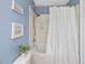 Bathroom featuring blue walls, shower, and white shower curtain at 2021 Rivergate Rd # 102, Raleigh, NC 27614