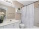 Bright bathroom features a shower/tub combination and a sink with a large mirror and updated light fixture at 2021 Rivergate Rd # 102, Raleigh, NC 27614