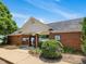 Community pool entrance features brick building with covered walkway and black metal fence at 2021 Rivergate Rd # 102, Raleigh, NC 27614