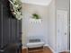 Cozy entryway with a decorative wreath, coat rack, and bench, creating a welcoming first impression at 2021 Rivergate Rd # 102, Raleigh, NC 27614