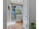 Bright foyer features hardwood floors, coat closet, and front door view at 2021 Rivergate Rd # 102, Raleigh, NC 27614