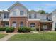 View of attractive townhouse exteriors with brick and siding, set amidst well-kept lawns and sidewalks at 2021 Rivergate Rd # 102, Raleigh, NC 27614