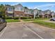 View of the exterior of the brick and siding townhomes, parking spaces, and green landscaping at 2021 Rivergate Rd # 102, Raleigh, NC 27614