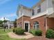 Charming townhome with a welcoming front entrance, well-maintained landscaping, and brick facade at 2021 Rivergate Rd # 102, Raleigh, NC 27614